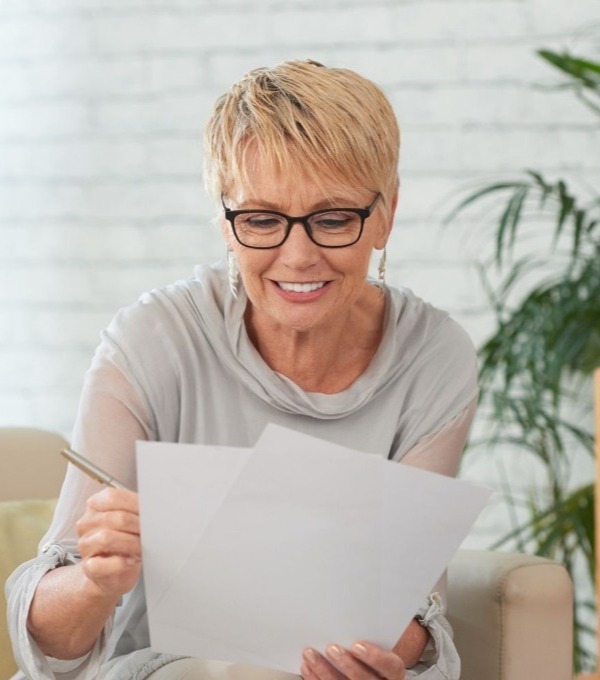 Senior businesswoman looking at documents smiling
